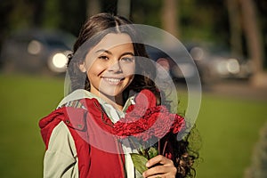 portrait of teen girl with autumn flowers bouquet. teen girl with autumn bouquet outside.