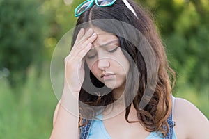 Portrait of teen girl busy problems in summer nature