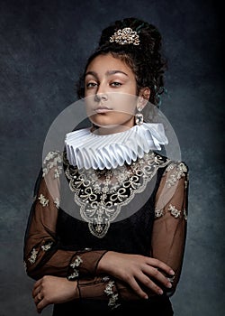 Portrait of a teen girl with dark curly hair, wearing a ruffled collar