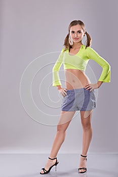 Portrait of a teen girl on a gray background in studio.