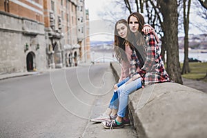 A Portrait of a teen girl with long hair in an urban