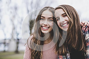 A Portrait of a teen girl with long hair in an urban