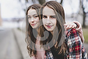 A Portrait of a teen girl with long hair in an urban