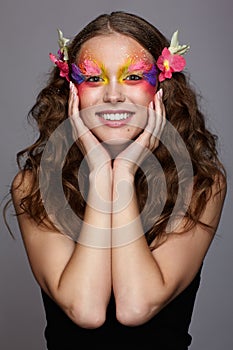 Portrait of teen girl with orchid flower in wavy hair