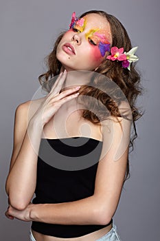 Portrait of teen girl with orchid flower in wavy hair