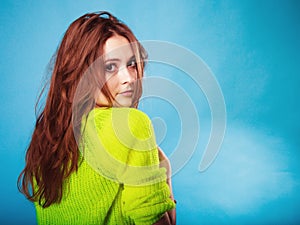 Portrait teen girl in vivid colour sweater on blue