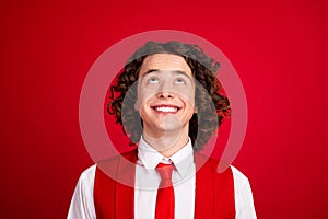 Portrait of teen guy wear necktie and formal clothing brunette curly hair look above head wait for event isolated on red