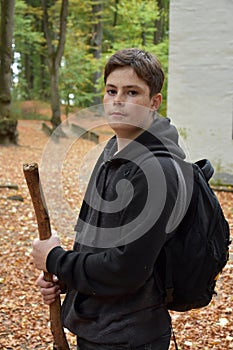 Portrait of a teenage boy in autumn forest