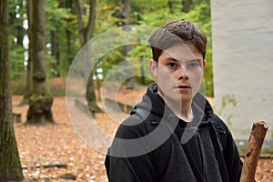 Portrait of a teenage boy in autumn forest