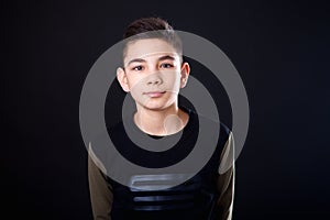 Portrait teenage boy on a black background.