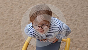 Portrait teenage boy children park. Glasses improve vision perception world.
