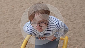 Portrait teenage boy children park. Glasses improve vision perception world.