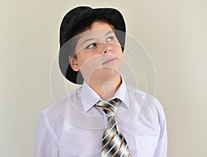 portrait of a teenage boy in hat and tie photo