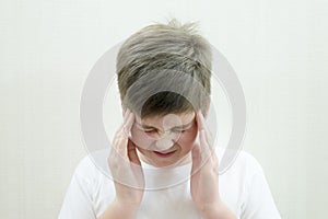 Portrait of teenage boy with a headache photo