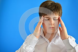 Portrait of teenage boy with a headache photo