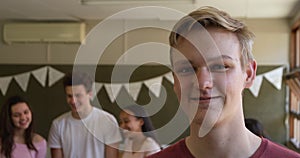 Portrait of teenage boy in school classroom