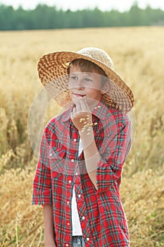 Portrait of teenage farm boy in wide-brimmed hat