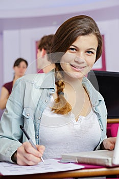 portrait teenage female student sat at desk