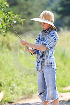 Portrait of teenage fisherman with rod