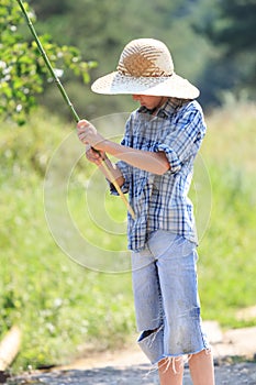 Portrait of teenage fisherman with stick