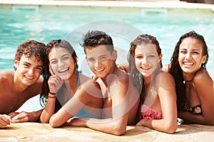 Portrait Of Teenage Friends Having Fun In Swimming Pool