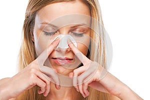 Portrait of teenage girl applying clear-up strips on nose