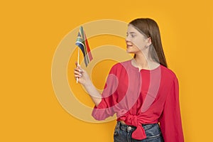 Portrait of teenage girl with flag of South Africa on an orange background. Study and travel in South Africa