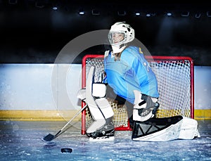 Girl goaltender protecting net during hockey match photo
