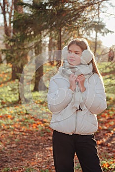 Portrait teenage girl looking away wearing casual fall clothes in an autumn natural park outdoors