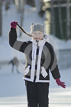 Portrait teenage girl with pigtailed wearing winter clothes in winter outside photo