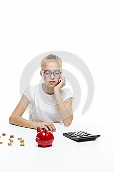 Portrait of Teenage Girl Posing With Coins and Moneybox. Calculating Income With Calculator