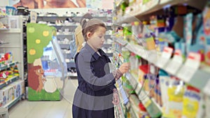 Portrait of teenage girl stealing groceries in a big store