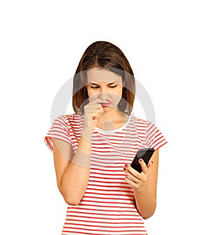 Portrait of teenage girl thinking seriously while holding a cellphone. emotional girl isolated on white background