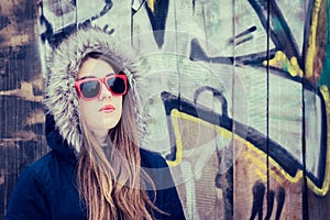 Portrait of a teenage girl wearing red sunglasses