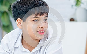 Portrait teenage Indian handsome boy wearing shirt, smiling with smart and happiness with copy space, staying in indoor house or