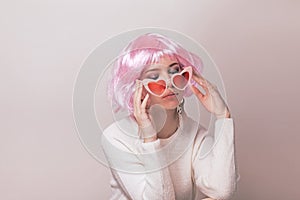 Portrait of teenage model with pink hair posing against pastel background