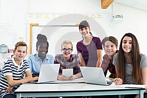 Portrait Of Teenage Students With Teacher In IT Class