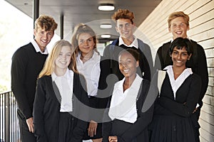 Portrait Of Teenage Students In Uniform Outside School Building