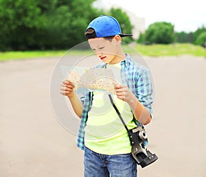 portrait teenager boy tourist sightseeing city with a paper map
