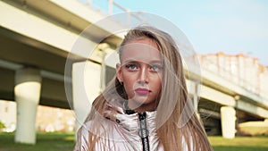 Portrait teenager girl with bright makeup lips and eyes on car bridge background. Face blonde teenager girl with long