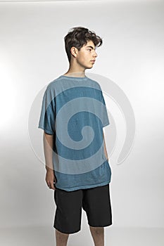 Portrait of teenager on white background in studio. The boy is standing