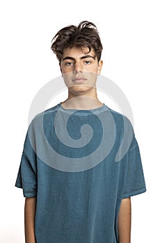 Portrait of teenager on white background in studio. The boy is standing