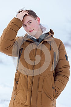 Portrait of a teenager in winter, there is snow around