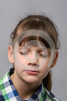 Portrait of a ten-year-old girl with closed eyes, European appearance, close-up