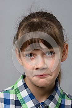 Portrait of a ten-year-old girl with a pitying look, European appearance, close-up