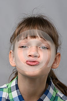 Portrait of a ten-year-old girl showing a kiss, European appearance, close-up