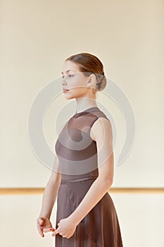 Portrait of tender beautiful teen girl, ballerina dancer posing in ballet studio, school indoors on a daytime. Elegance