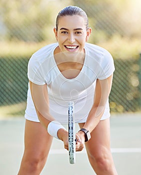 Portrait of a tennis woman with a racket on the tennis court, getting ready for a match. Young competitive tennis player