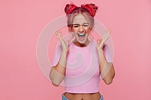 Portrait of terrified young woman with colorful hairstyle screaming in panic