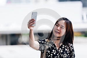 Portrait of thai adult beautiful girl using her smart phone Selfie